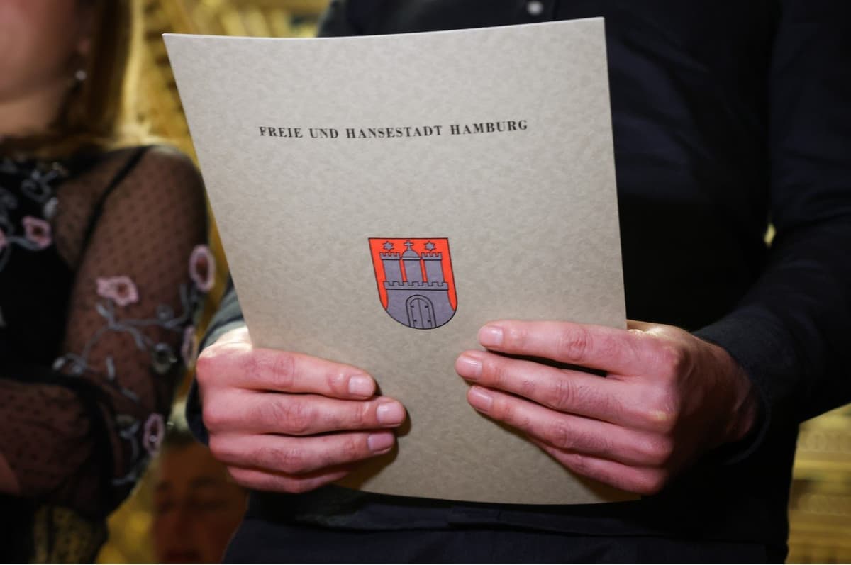 A person holding a German passport and flag