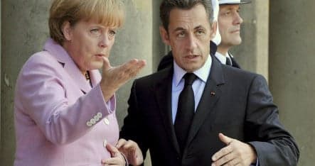 Merkel confers with Sarkozy and Bush over crisis