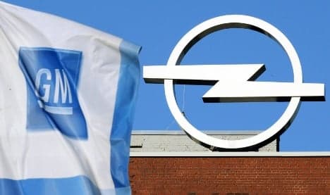 Merkel prods GM to decide Opel's fate