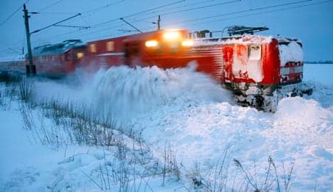 Train hits snow-clearing vehicle