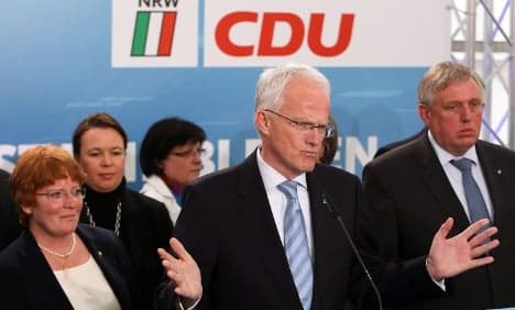 CDU defeat a 'double debacle,' press says