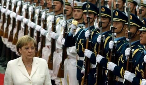 Merkel pushes China to open its markets