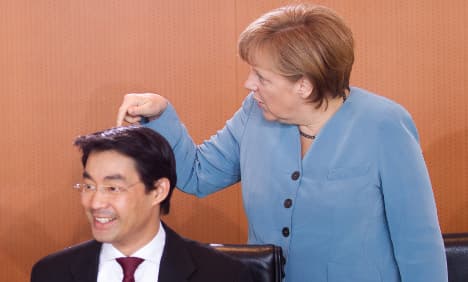 Merkel rides high as partner FDP nose-dives