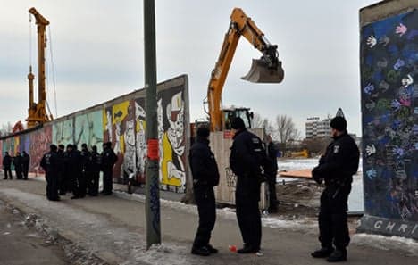 Part of Berlin Wall demolished at dawn