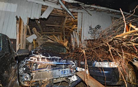 Airborne car smashes through barn