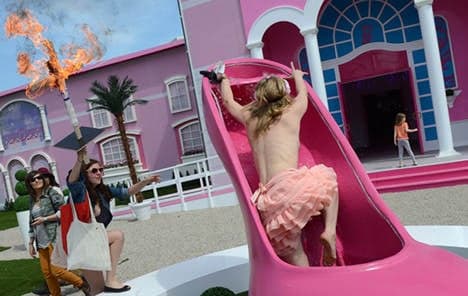 Giant Barbie doll house opens amid protests