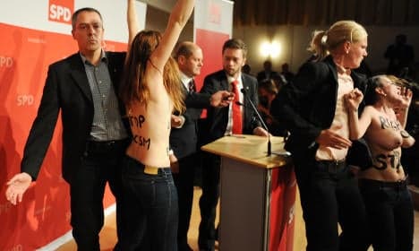 Mayor hit by topless protest over refugees