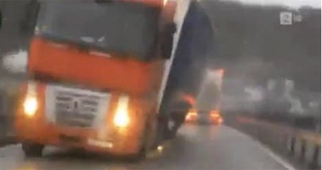 VIDEO: Trucks almost crush car in storm