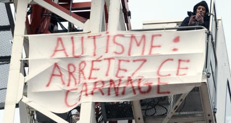 Protesting mother on perch above French city
