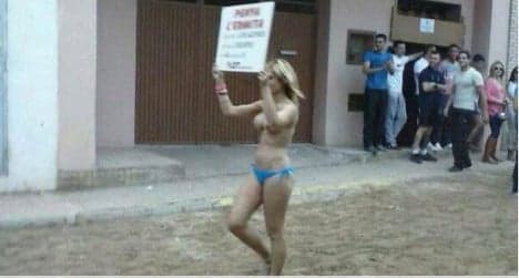 Topless woman touts for bull-running festival