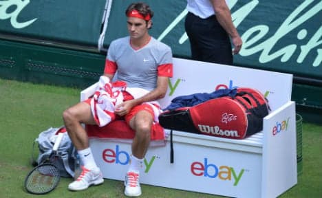 Federer reaches semis without hitting a ball