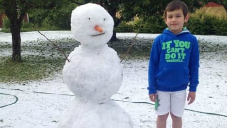 Swedish boy builds snowman in late June