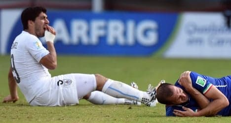 Suarez banned after taking bite out of Italy