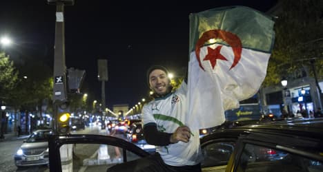 Jubilant Algeria fans take over Champs-Elysées