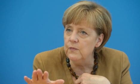 Merkel tells Putin to stop sending arms to Ukraine