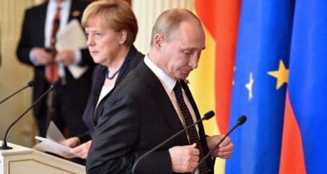 Merkel meets Putin for talks, snubs WWII parade