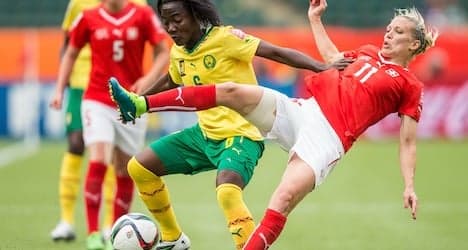 Swiss advance despite loss to Cameroon