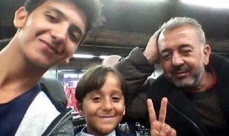 Syrian father and son tripped up by camerawoman find home in Madrid
