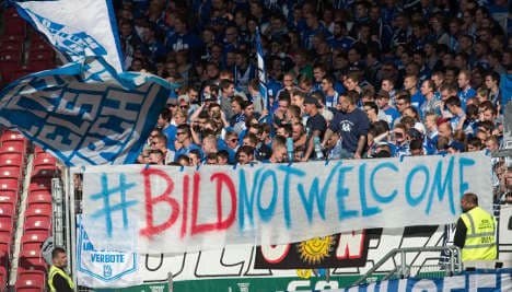 Football fans show anger at Bild over refugees