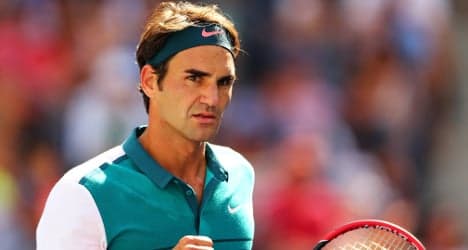 Federer sets up clash with big serving Isner