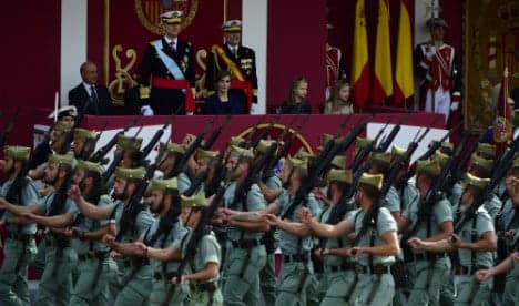 Spanish royals celebrate national day military parade amid protests