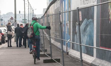 Berlin Wall fenced off to save graffiti from vandals