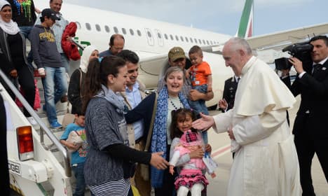 Pope Francis takes 12 refugees back to Vatican