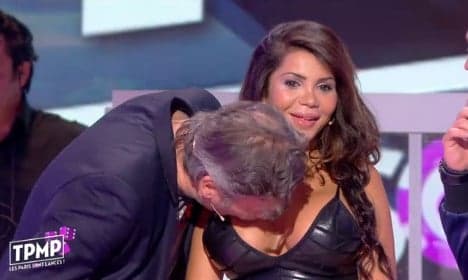 Anger after presenter kisses woman's breasts on live TV