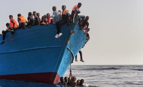 Armed men attack migrant boat, killing at least four