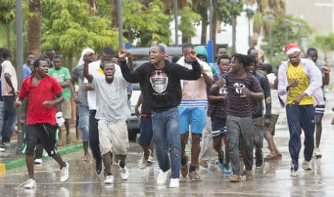 Migrants jump Spain-Morocco border fence in heavy rain
