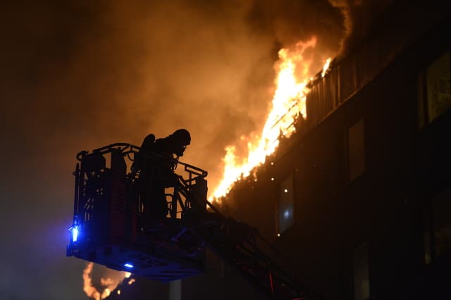 Firefighters tackle blaze in seven-storey building next to preschool