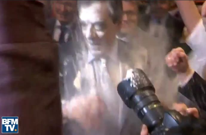 Fillon (and his suit) hit by flour power at campaign rally