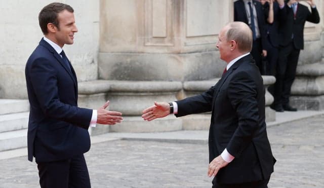 Macron and Putin hold face-to-face talks in splendour of Versailles