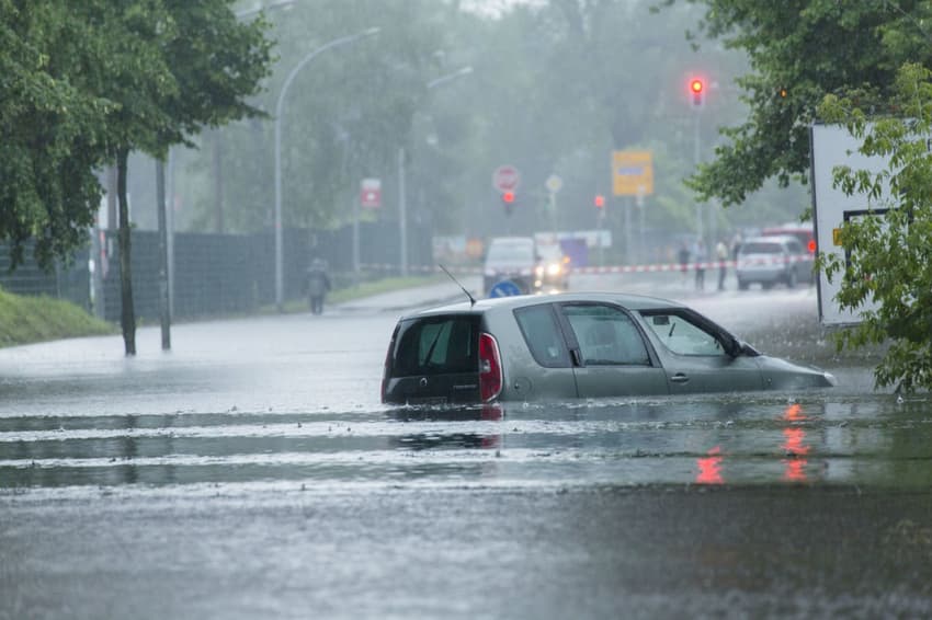 Berlin firefighters work to tackle flooding after 'heaviest rain in a century'