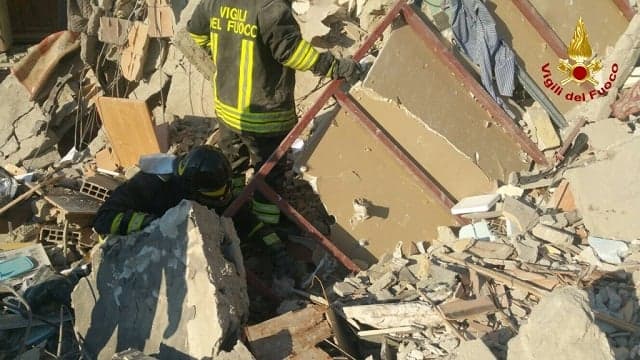No signs of life as firefighters search for two families feared missing after building collapse