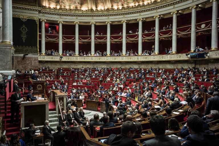 French lawmakers banned from wearing religious symbols... and football shirts in parliament