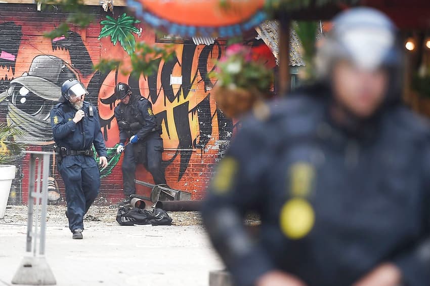 Danish police arrest 13 in tense Christiania raid