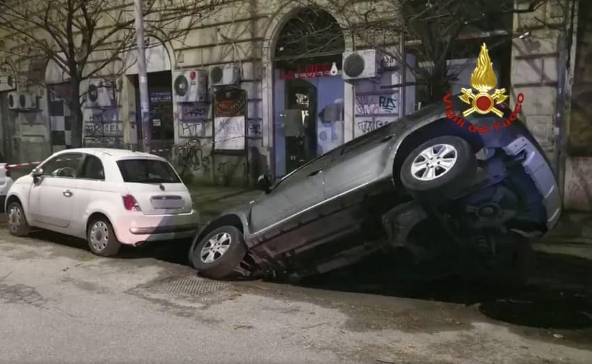 Giant pothole sinks two cars in Rome