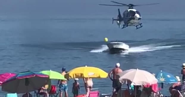 Video: Police chopper chases down speedboat smuggler at busy Spanish beach