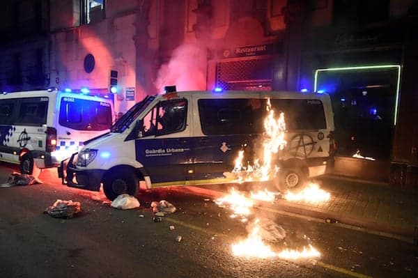 Police van torched in Barcelona protest against rapper's jailing