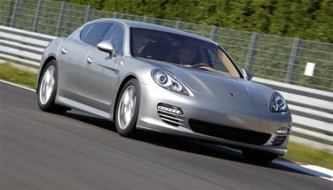 Porsche sheds debt but expects yearly loss
