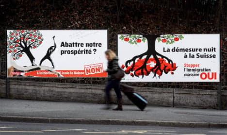 Swiss voters narrowly back immigration curbs