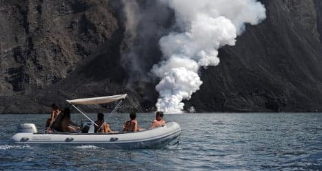 Tourists flock to Italy’s erupting volcano