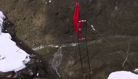 Norway man in 'human flag' stunt over waterfall