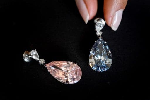 Diamond earrings sold for record $57m at Geneva auction