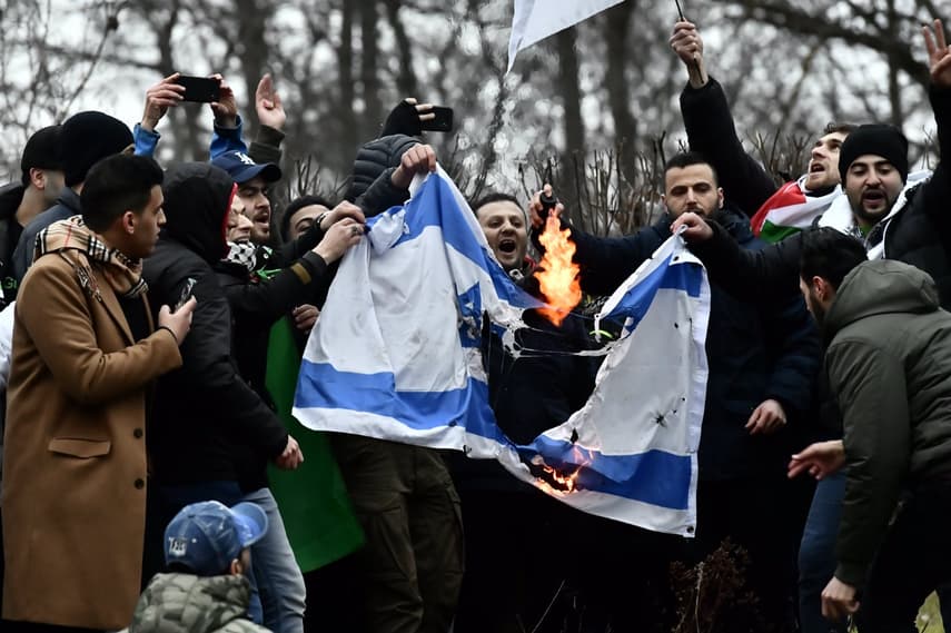 Demonstrators in Stockholm set fire to Israeli flag