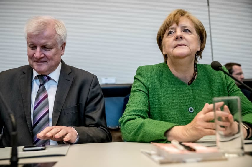 Merkel tries to calm coalition quarrel as interior minister gets tough on asylum