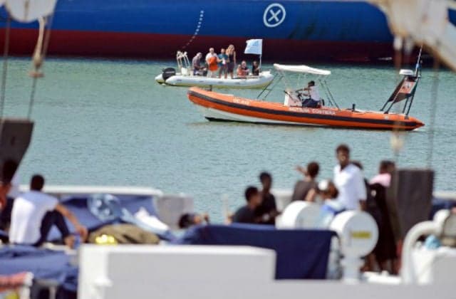 Italy lets migrants off stranded boat as deal reached