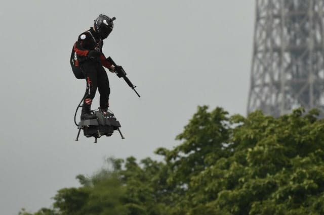 French inventor soars on flyboard above Bastille Day parade