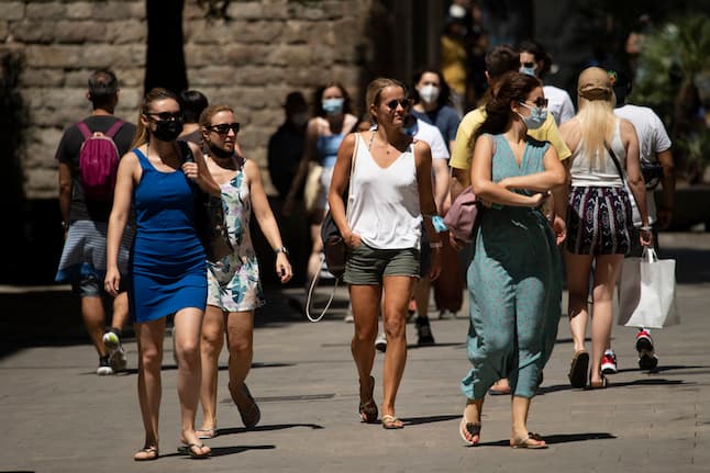 Spain drops masks outdoors but most faces stay covered